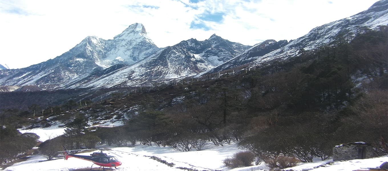 Helicopter flying among Himalayan peaks in the Everest region