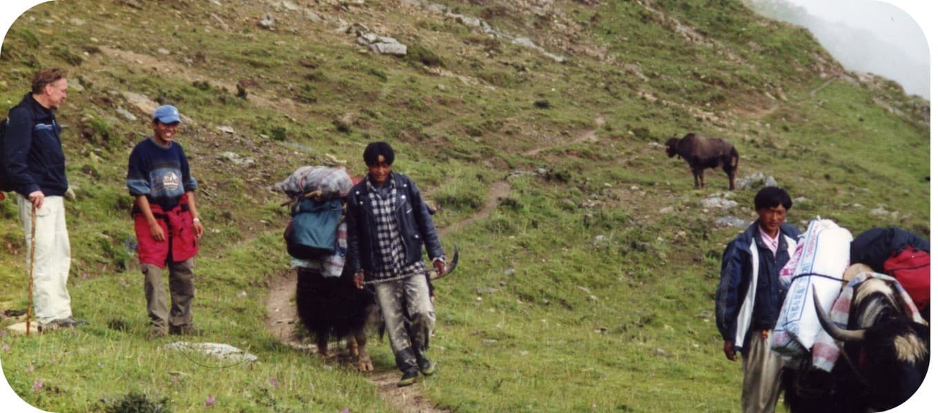 Trekkers crossing high pastures on the Ganden to Samye trek